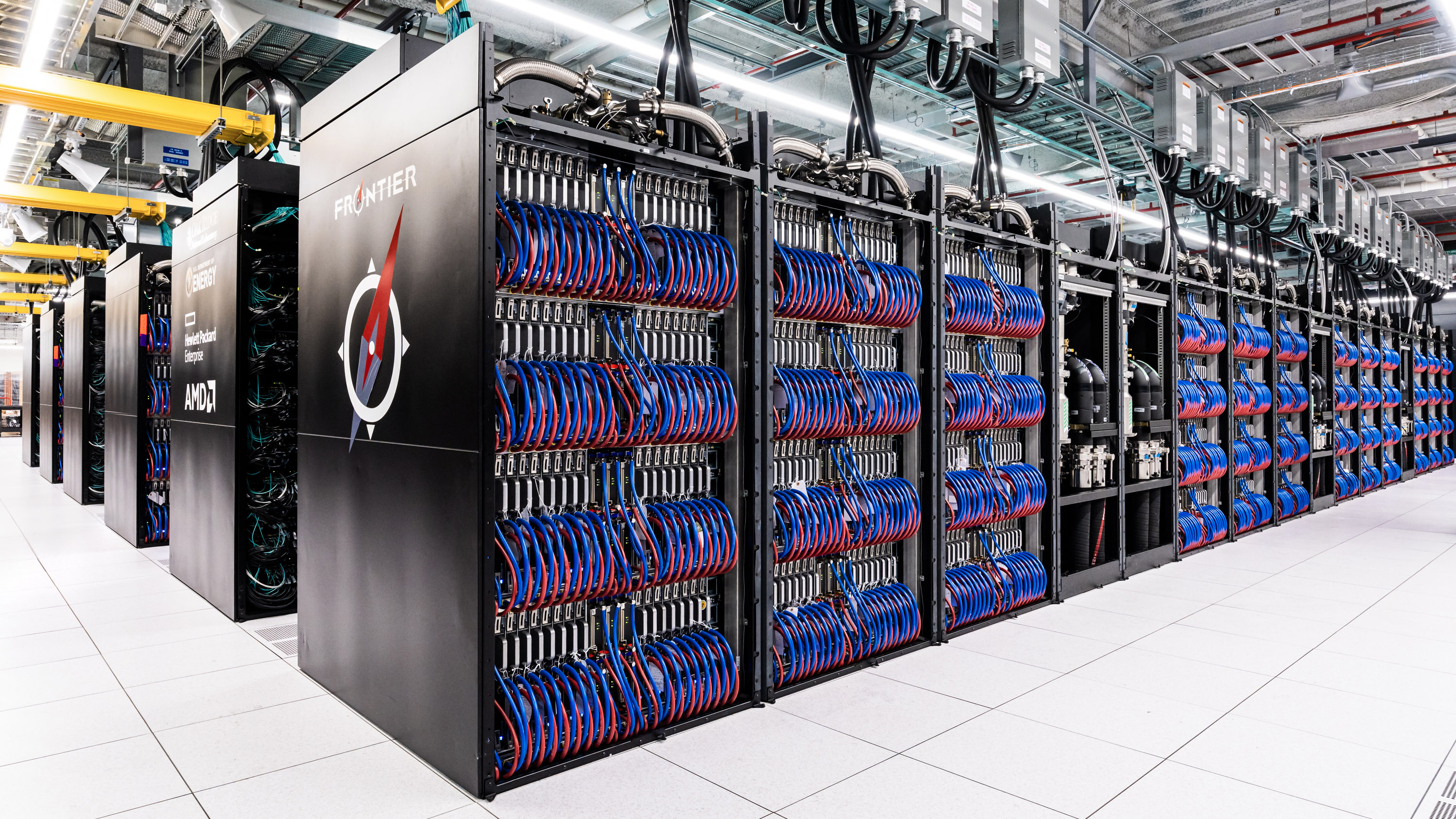 Long rows of supercomputers with the name &quot;Frontier&quot; visible on the end