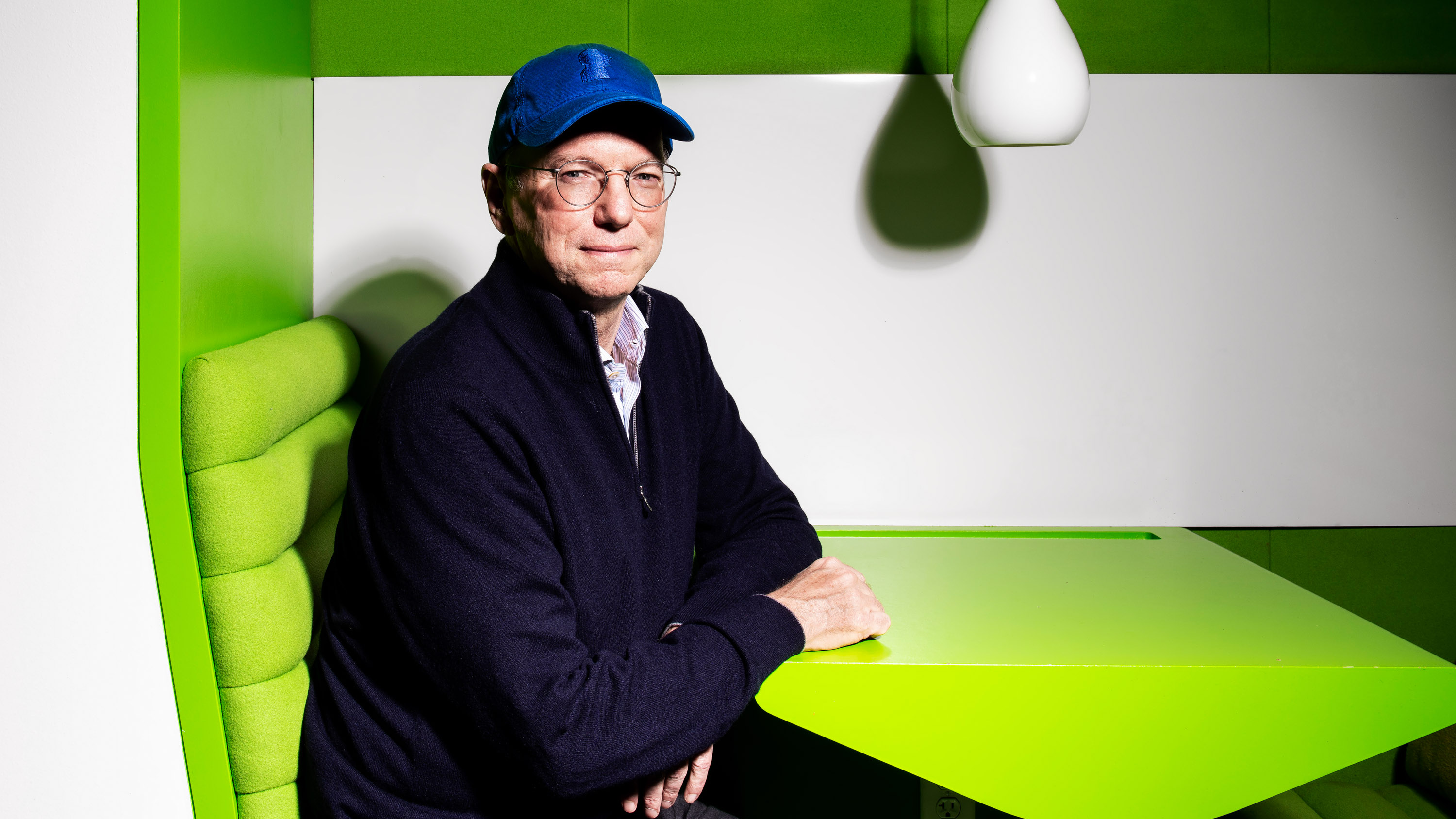 Eric Schmidt seated in a booth at Googleplex